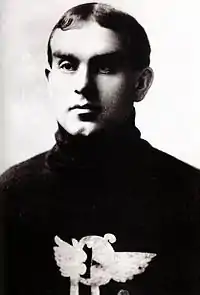 Profile photo of a young man wearing a sweater with a logo on his chest