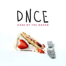 A piece of cake on a white background with a knife and the words "DNCE: Cake by the Ocean".