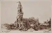 1914–1917, Daily Mail Official War Photograph, "The Church at Albert". "Passed by Censor" and "The Germans bombardment caused this strange bending downwards of the Virgin and Child on Albert Church tower."