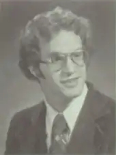 Portrait of teenage man with glasses wearing a suit