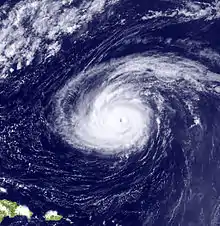 A satellite image depicting a mature hurricane with a well-defined eye far away from landmasses.