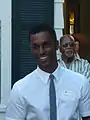 Crew cut: top, medium; back/sides, semi-short taper; sideburns, long; short pomp (pompadour) front, arched; mid top, rounded; crown, rounded; front hairline, average, very curly hair.