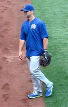 Man wearing gray uniform on a baseball infield