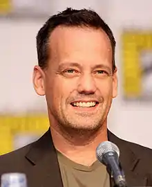 A closeup of a man in front of a microphone.