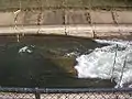 Middle Hole at low flow 200&nbsp;cu&nbsp;ft/s (5.7&nbsp;m3/s), revealing the underwater rock that creates it.
