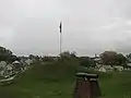 Doubleday Hill Monument shown with Flag and Cannon