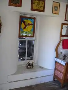 Window set in wall about 2 feet thick; window well is beveled, widening toward the interior
