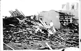 Pile of collapsed timber and assorted bricks