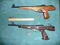 A complete Dub'l Duck above an unfinished Dub'l Duck, which resembles a Remington XP-100.