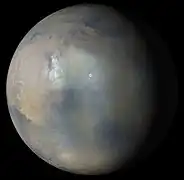 Multiple images from the MARCI were used to generate this view of a regional dust storm obscuring Syrtis Major and Jezero Crater (white circle). The images were acquired on Jan. 9, 2022.