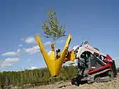 A tree spade on a Takeuchi tracked compact loader