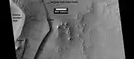 Layers under cap rock of a pedestal crater, as seen by HiRISE under HiWish program.  Pedestal crater is within the much larger Tikhonravov Crater.