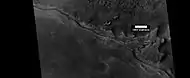 Wide view of mesa breaking up into rocks, as seen by HiRISE under HiWish program Parts of this image are shown enlarged in the next two images.
