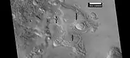 Brain terrain being formed from a thicker layer, as seen by HiRISE under HiWish program.  Arrows show the thicker unit breaking up into small cells.