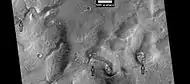 Layered features in channels and depressions, as seen by HiRISE under HiWish program Arrows point to some of the layered features.