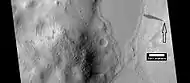 Layers and dark slope streaks, as seen by HiRISE under HiWish program  Arrow indicates the small spot where the streak started.