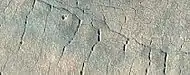 Close, color  view of lines of pits, as seen by HiRISE under HiWish program