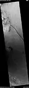 This long, straight ridge may be a dike that has been exposed by erosion.  It was initially formed by magma moving under the surface.  The picture was taken with HiRISE under the HiWish program.