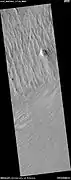 Wide view of yardangs, as seen by HiRISE under HiWish program  This image is odd in that the yardangs are lined up in different directions in the top and bottom part of image.  The wind direction probably changed to cause this.  Location is Memnonia quadrangle.