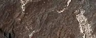 Close view of light-toned materials, as seen by HiRISE under HiWish program Light-toned materials have been associated with water.