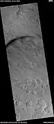 Scalloped terrain, as seen by HiRISE under HIWish program Dust devil tracks are also visible.