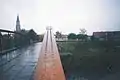 Old bridge over Begej 1995 with sheep and church in background