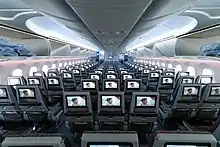 Airline business cabin. Rows of seats arranged between aisles.