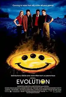 Four people standing behind a fiery yellow smiley face with three eyes