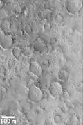 The northern hemisphere appears smooth, but the craters are covered over.  Here, a group of craters are partially exposed.  Image located in Cebrenia quadrangle.