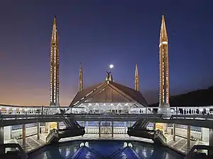 Image 7The Faisal Mosque (Urdu: فیصل مسجد) is a mosque located in Islamabad, Pakistan. It is Located on the foothills of Margalla Hills in Islamabad, the mosque features a contemporary design consisting of eight sides of concrete shell and is inspired by a Bedouin tent, and is considered to be the city's main Landmark.US Department of Defense (edited by Jjron)