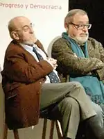 Two seated, middle-aged men