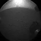 Curiosity's first image after landing – The rover's wheel can be seen (August 6, 2012).