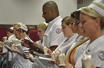 Nursing student graduate Luis Figueroa (center) participates in the reading of the International Nurses' Pledge during Germanna Community College's Nursing and Health Technologies convocation, held at the Fredericksburg Expo and Conference Center in Fredericksburg, Virginia, USA.