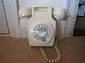 711 Wall mounted Ivory Telephone, strangely photographed sitting on the floor.