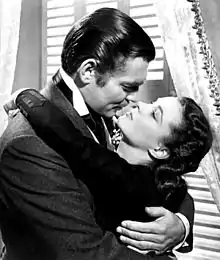  a man and woman in profile are in a passionate embrace as if about to kiss