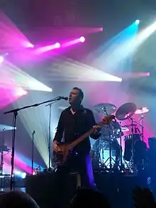 Grimes performing with Simple Minds in 2013