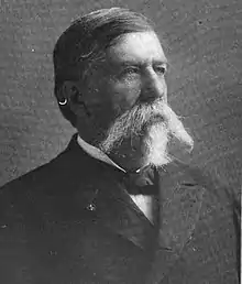Black and white head and shoulders photo of George Spalding looking left