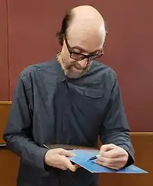 George Winston autographs a copy of his album Autumn at the Robinson Grand Performing Arts Center in Clarksburg, WV