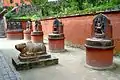 Statues of Nandi (in the foreground), Pande and his two wives, Vishnu, bearded Brahma, Brindi Bhairab and Nandi Bhairab (along the wall from left to right)
