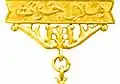 The golden bar and the suspension decoration as displayed.