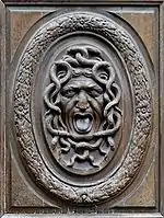 A wooden gorgoneion on the door of a Parisian hotel to guard the establishment from unwanted guests, by Thomas Regnaudin c. 1660.