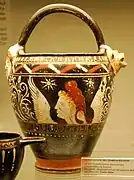 A Gnathia-style ceramic vessel with lion-head spouts from ancient Magna Graecia (Apulia, Italy), depicting a blond winged youth with a Phrygian cap, by the "Toledo" painter, c. 300 BCE.