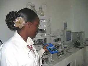 Image 5A technician at the Guyana Food and Drug Department Laboratory in Georgetown, Guyana selecting peanut samples to be tested with new equipment. (from Agriculture in Guyana)