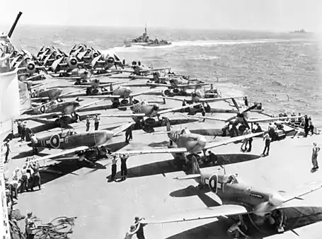Royal Navy Fleet Air Arm Avengers, Seafires and Fireflies on HMS&nbsp;Implacable warm up their engines before taking off.
