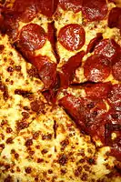 Pepperoni on a pizza.