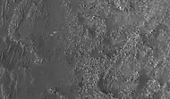 Image of Perseverance (center) on fractured bedrock several kilometers from its primary science target, taken by HiRISE on February 26, 2022.