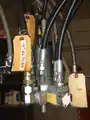 A high-pressure mix head, showing material supply and hydraulic actuator lines (rear view)