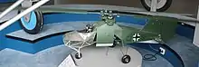 a colour photograph of a scale model of a green mini-helicopter