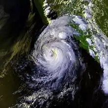 Satellite image of a tropical cyclone in the northeast Pacific Ocean. The hurricane has a ragged eye.