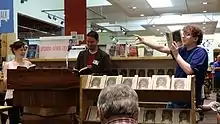 At Powell's Bookstore in Portland, Oregon. Doescher (center) does a reading of The Jedi Doth Return with former classmate Anne Huebsch (left) and audience member Micah Read from Lincoln High School  (right). July, 2014.